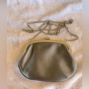 Liz Claiborne clutch with silver metal hardware and strap. Strap has 23” drop.
